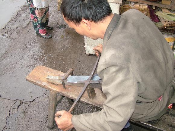 Chinese Smith using Sen and work bench or horse.